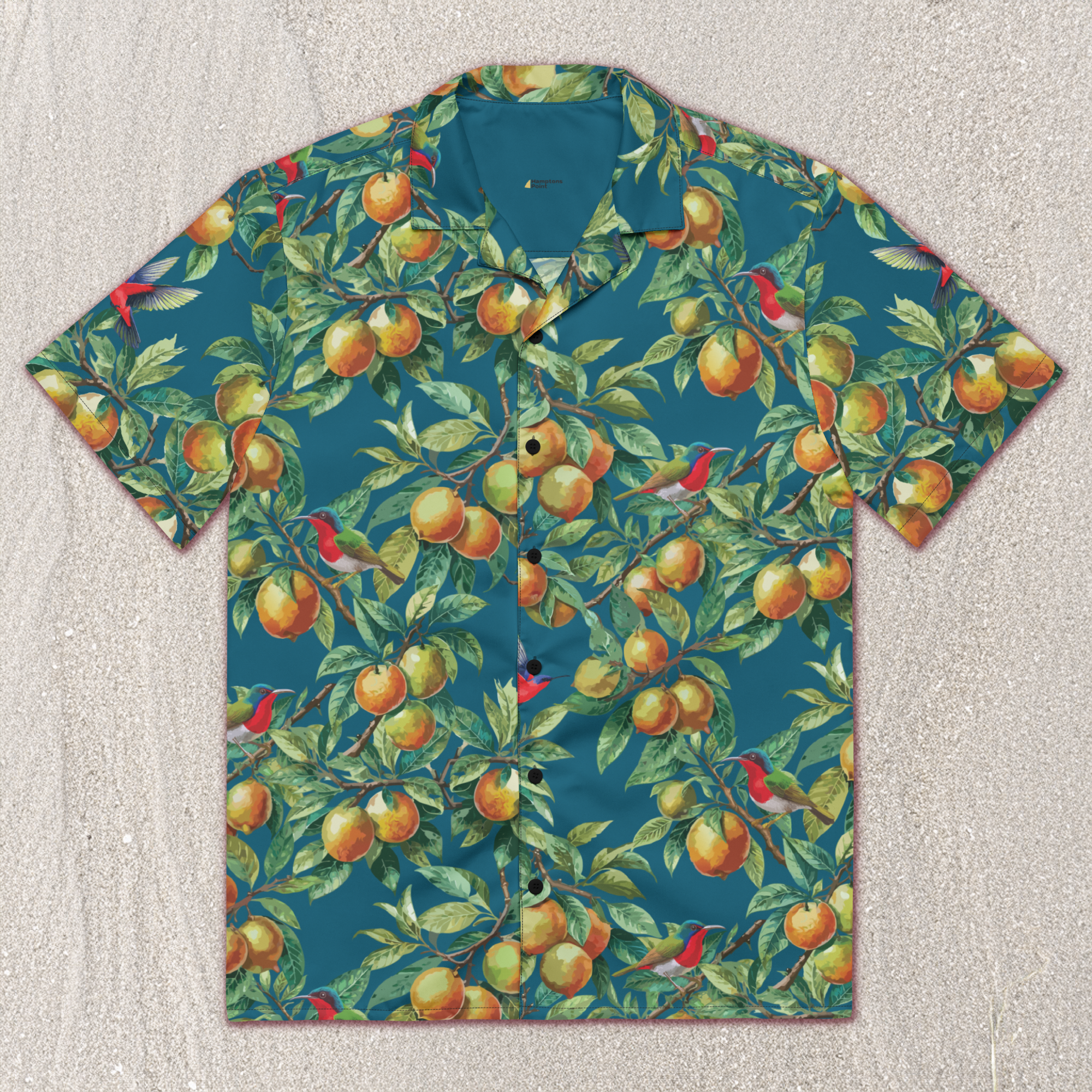 front of teal, yellow citrus print hawaiian shirt with red birds in boughs of citrus tree